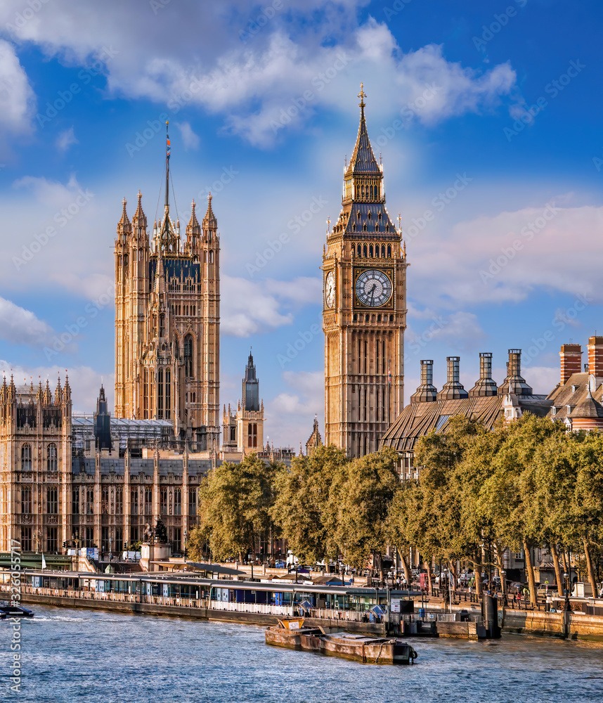 Big Ben and Houses of Parliament with boats on the river in London, England, UK